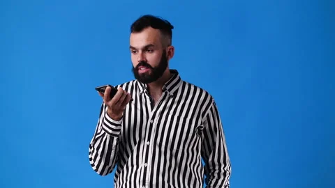 4k video of one man using phone over blue background. Video stock 236411058