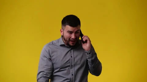 4k video of one man using phone over yellow backgrpound. Stock Footage 237509793