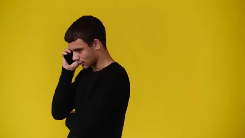 4k video of one man using phone over yellow background. Video stock 243634644