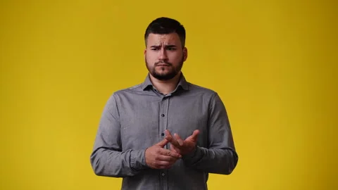 4k video of one man who planning to do something over yellow background. Stock Footage 244242995