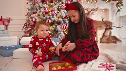 4k video portrait of two cute little children eating Christmas sweets. Baby Stock Footage 166534797
