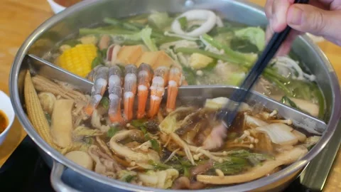 4k video POV while putting pork slice meat into hotpot shabu shabu Stock Footage 161888991