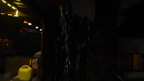 4K video of rain falling at night, illuminated by backlight. Raindrops visible Stock Footage 317950306