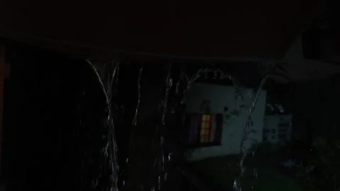 4K video of rain falling at night, illuminated by backlight. Raindrops visible Stock Footage 317950429