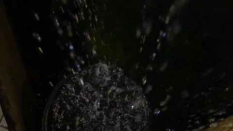 4K video of rain falling at night, illuminated by backlight. Raindrops visible Stock Footage 317950700