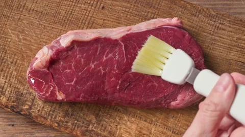 4K Video of Raw Beef Rump Steak Brushed with Oil Before Seasoning Stock-Footage 332158230