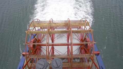 A 4k video of a red paddle wheel on the back of a paddle boat. Stock Footage 270202159