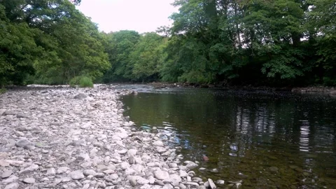 4K Video of river gentle cascading over stones in Cumbria Stock Footage 132137553
