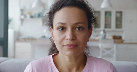 4K video of a serene middle Eastern ethnicity woman looking at camera sitting on Stock Footage 158428961