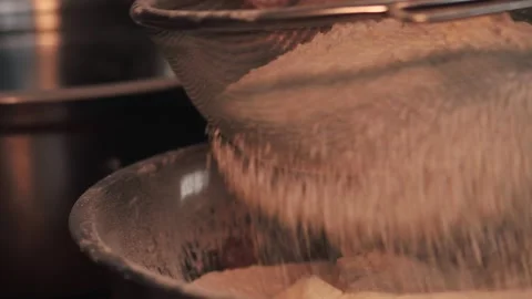 4k video sifting flour with a sifter. Food preparation concept. Stock Footage 262653369