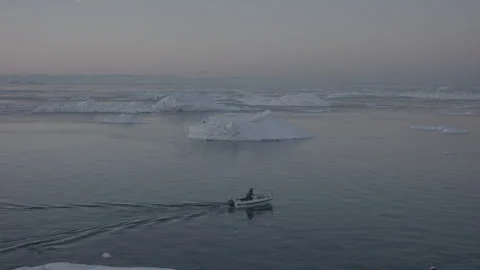 4K Video of Small Boat Navigating Through Arctic Sea Ice at sunset Stock Footage 314516685