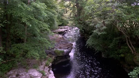 4K video of a small waterfall in a narrow river gorge in Cumbria UK Stock Footage 132132524