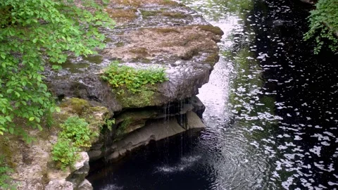 4K video of a small waterfall in a narrow river gorge in Cumbria UK Stock Footage 132134785