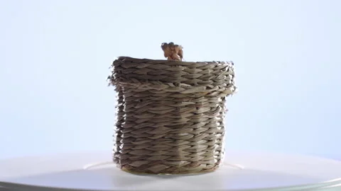 4k video of a small wicker basket spinning on a turntable. Selective focus Stock Footage 144846692