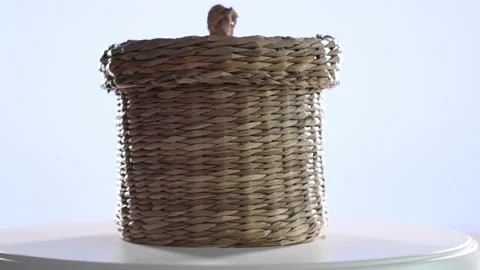 4k video of a small wicker basket spinning on a turntable. Selective focus Stock Footage 144847483