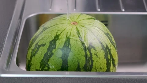 4k video of tap water flows onto ripe watermelon. Stock-Footage 243991682