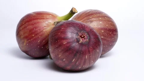 4K video of three figs turning on white background . Stock Footage 309511373