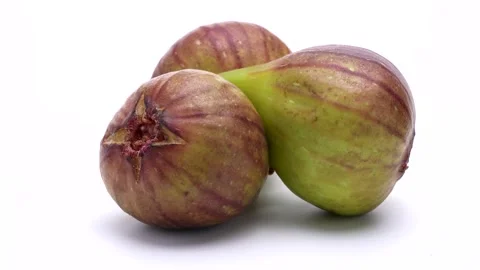 4K video of three figs turning on white background . Stock Footage 311032198