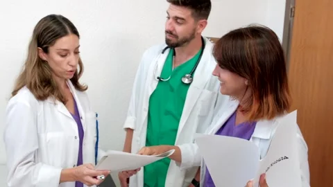4K Video of three young and happy doctors working in a hospital. Stock Footage 282039414