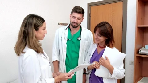 4K Video of three young and happy doctors working in a hospital. Stock Footage 282039415