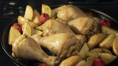 4K video time lapse chicken legs potatoes tomatoes cooking baking in the oven Stock Footage 244393172