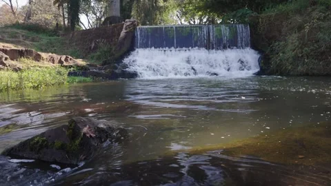 A 4K video of a tranquil cascading water fall and a flowing river. Beauty Stock Footage 278817161