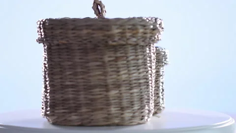 4k video of two small wicker baskets spinning on a turntable. Selective focus Stock Footage 144846773