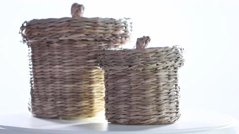 4k video of two small wicker baskets spinning on a turntable. Selective focus Stock Footage 144849683
