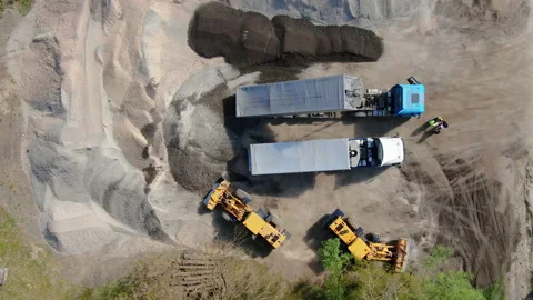 4K video. Two trucks pour rubble. From a bird's eye view. Stock Footage 130191988