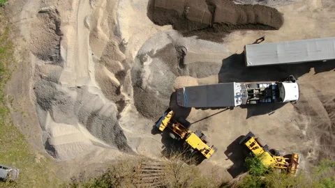 4K video. Two trucks pour rubble. From a bird's eye view. Stock Footage 130192344
