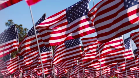 4K video of USA flag waving in the air with sunlight in the background with wind Video stock 243783163