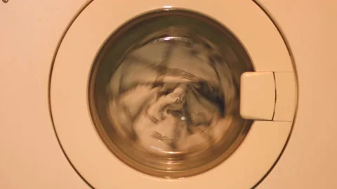 4k video of a washing machine spinner, orange color because of the lighting. Stock Footage 141576281
