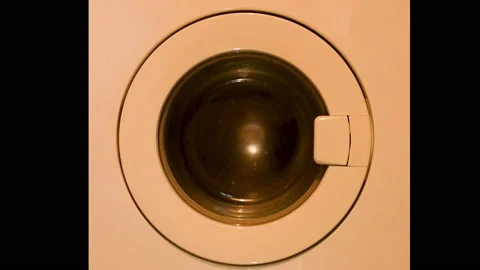 4k video of a washing machine spinner, orange color because of the lighting. Stock Footage 141579032