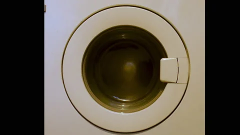 4k video of a washing machine spinner, orange color because of the lighting. Stock Footage 141580993