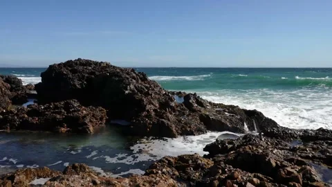 A 4K video of waves knocking and crashing against rocks at the coastline Stock Footage 221427895