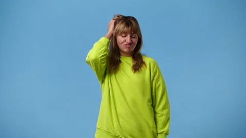 4k video of a woman thinking about something over blue background. Stock Footage 242596257