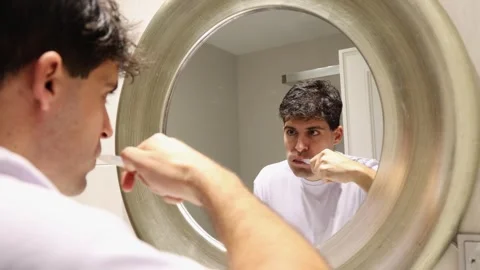 4k video young man brushing his teeth Stock Footage 262110175