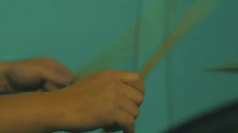 4k video of Young man playing with drum sticks Video stock 83886135