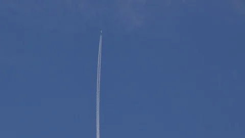 4K View of Airplane jet layer, aircraft pollution on sky, white trace vapour by Stock Footage 92945524