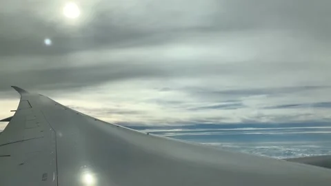 4k View of airplane window of the airplane wing, blue sky, and white clouds Stock Footage 156261104