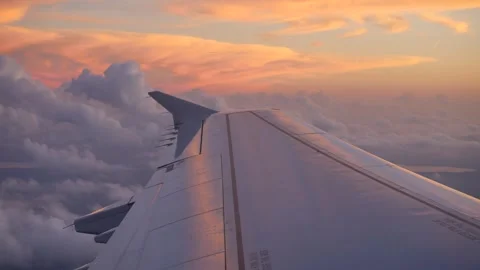 4K View from Airplane Window Wing Against Vibrant Sunset Sky Clouds Stock-Footage 334443685