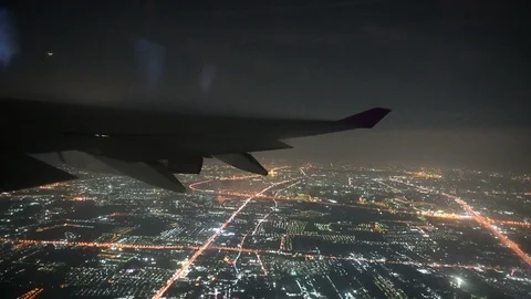 4K View from airplane wing flying at night over big city Stock Footage 101035166