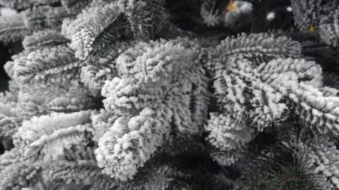 4K view of an artificial Christmas tree with snow-covered branches Stock Footage 253113171