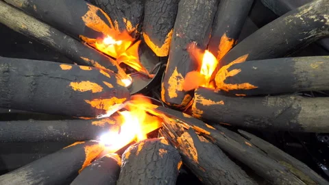 4K view of artificial logs lying around and a fire Stock Footage 128112145