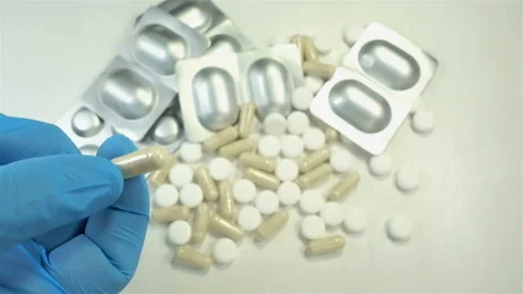 4K view of a blue gloved hand holding a medical capsule Stock Footage 140744054