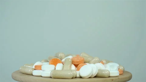 4K view of a bunch of colored pills rotating Stock Footage 140686989