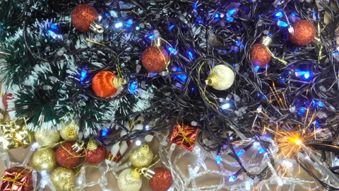 4K view of a burning sparkler and Christmas decorations Stock Footage 142558532