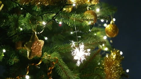 4K view of a burning sparkler on Christmas tree Stock Footage 143825327