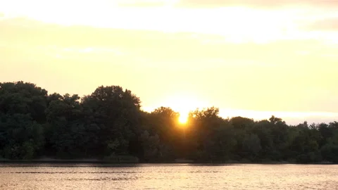 4K view of the calm flow of the river, forest and sunset Stock-Footage 116269980