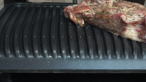 4K view of the chef's hand putting meat on the grill Stock Footage 199678928